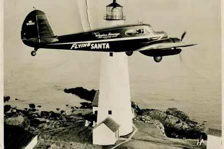 Flying Santa plane flies past Boston Light in 1947.