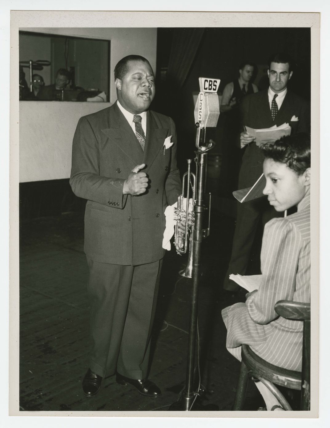Photograph of Louis Armstrong recording at the CBS Studio in New York