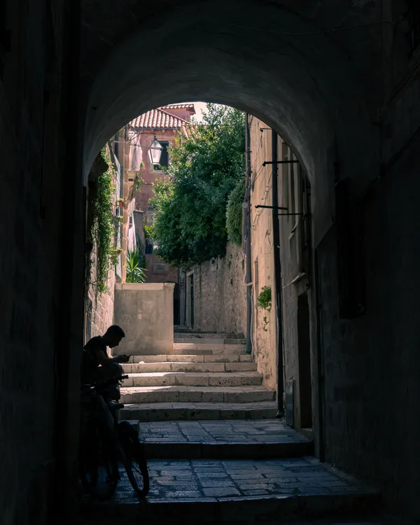 Man and his bicycle in a Dubrovnik Side Street thumbnail