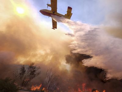 One of precious few purpose-built firefighting airplanes, a Bombardier CL-415 drops water on a fire in Simi Valley, California in November 2018. Over 870,000 acres of California land burned last year, according to Cal Fire.