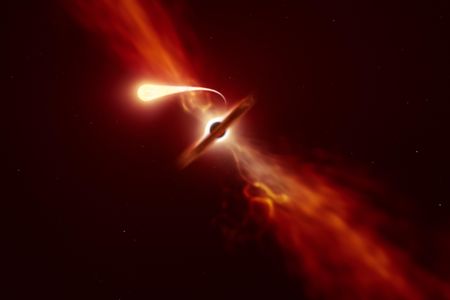 This illustration depicts a star (in the foreground) experiencing spaghettification as it's sucked in by a supermassive black hole (in the background) during a 'tidal disruption event'.