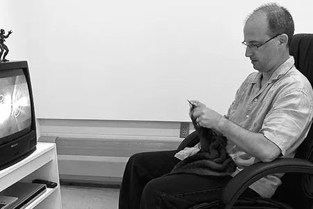 Artist Mark Newport replaces the flashy capes and skin-tight garments of comic book superheroes with soft, hand-knit costumes.