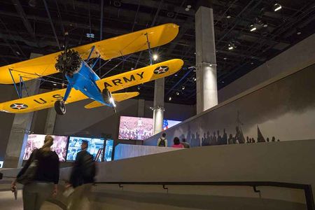 The “Spirit of Tuskegee” hangs from the ceiling at the Smithsonian’s National Museum of African American History and Culture. The blue and yellow Stearman PT 13-D was used to train Black pilots from 1944 to 1946.