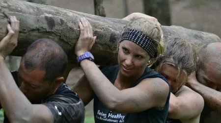 Participants in a MovNat course carry logs and perform other backwoods workout drills with the goal of retraining their bodies to a level of fitness that our species forgot long ago.
