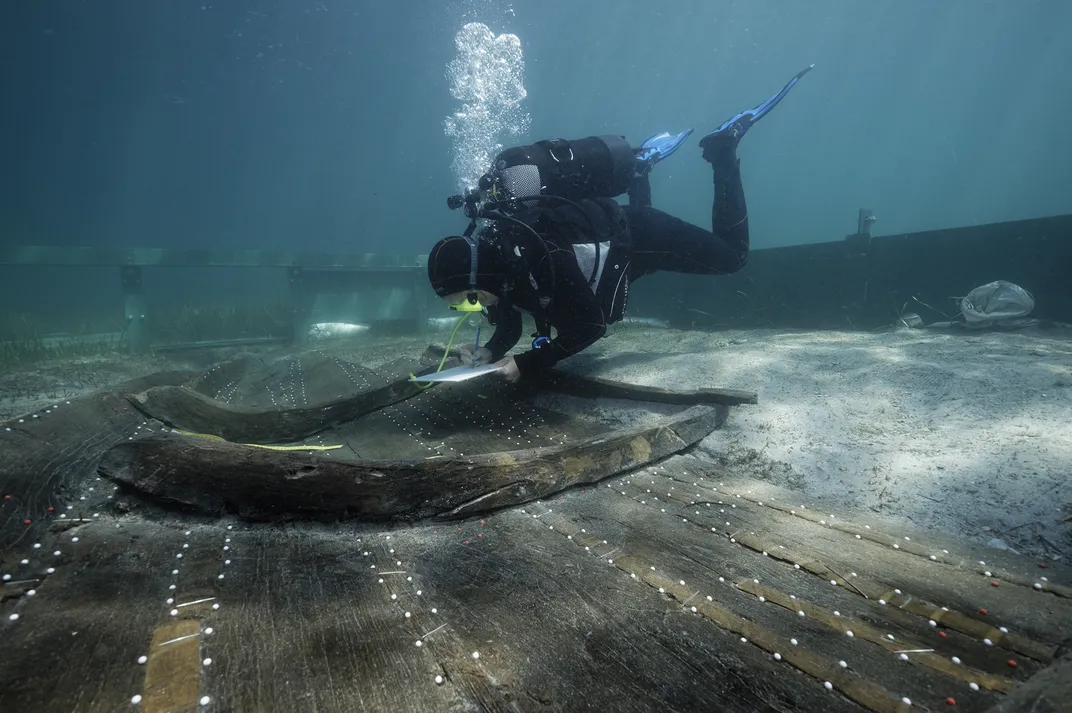 Underwater diver studying shipwreck