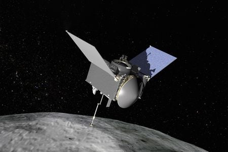 An uncrewed spacecraft with three main components is seen orbiting above an asteroid.