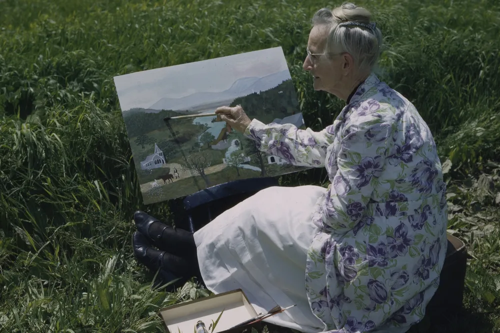 Moses painting in garden, photo by Ifor Thomas, 1946