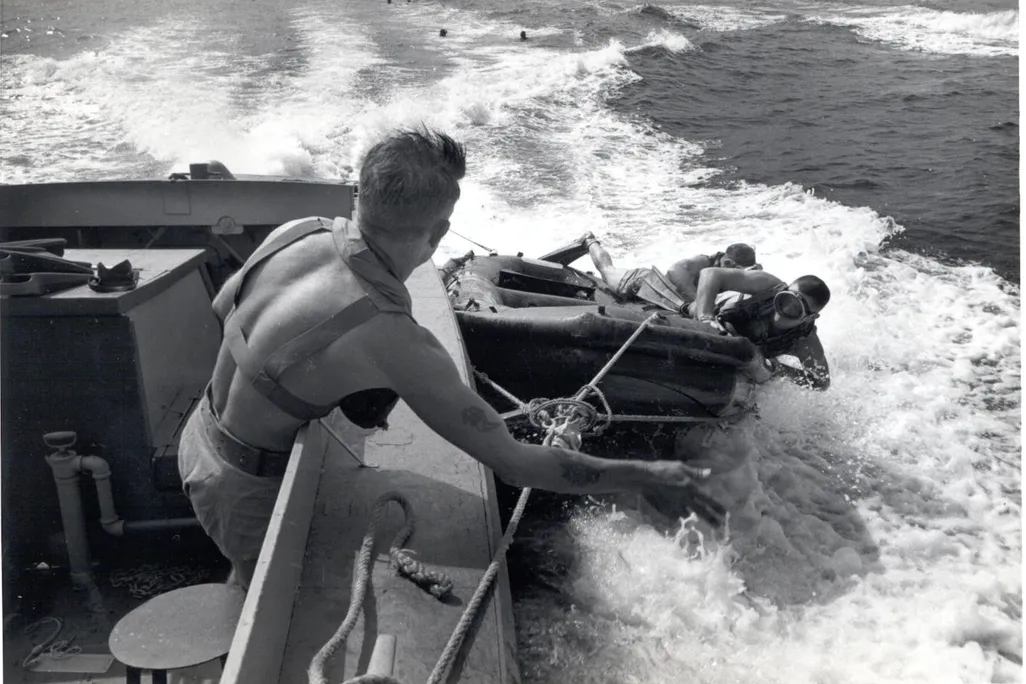UDT members deploying from a speeding landing craft