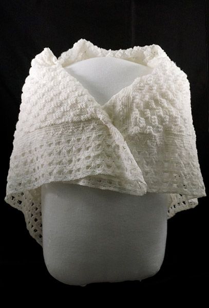 White shawl wrapped around mannequin's shoulders