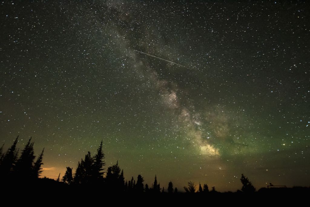 A shooting star streaks across a star-filled sky in British Columbia