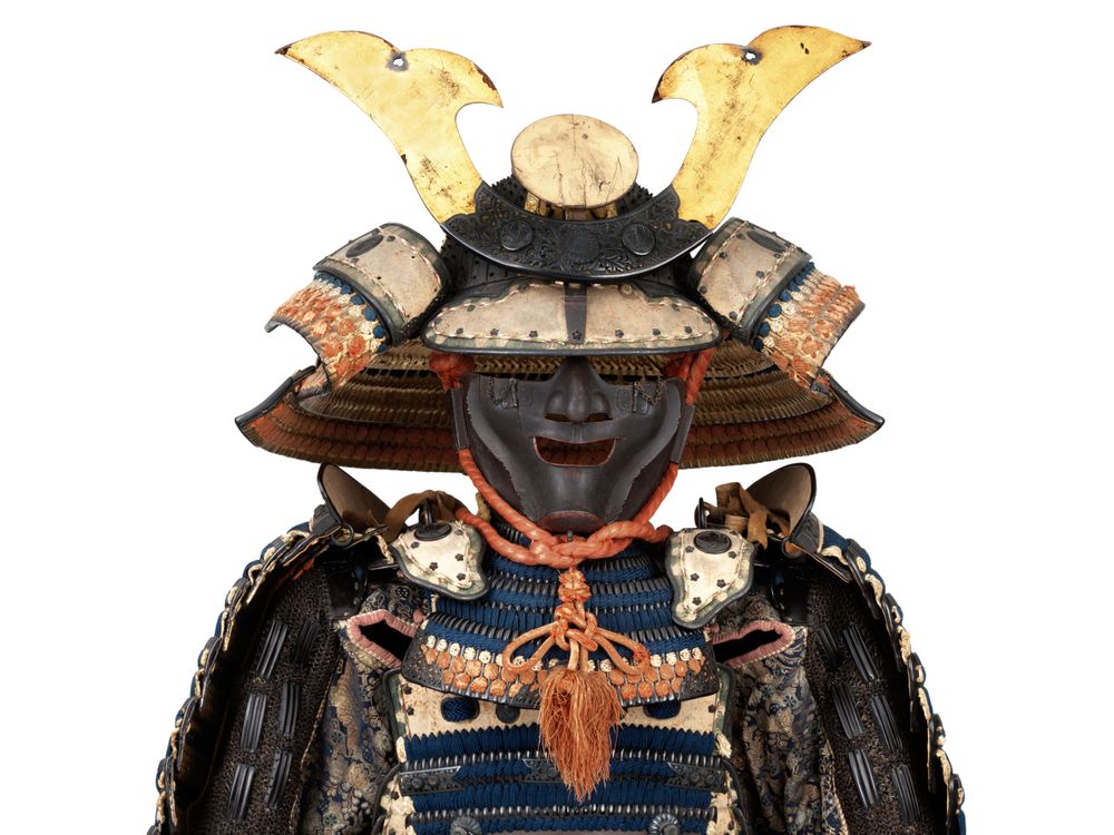 OPENER DETAIL - This suit of  armor bears the crest of the powerful Ikeda family. The helmet dates to the 14th century, and the suit—including the bear-fur shoes—dates to the 18th.