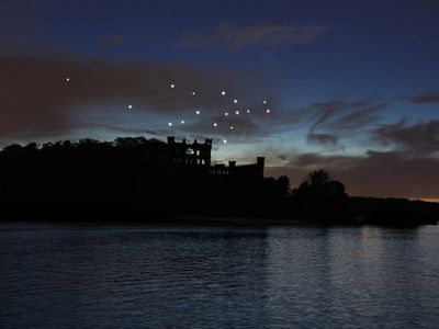 A rendering of the installation, which officially launches June 28. Seventeen artist-made stars will glow each night in a constellation above an abandoned castle.