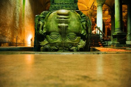 In an eerie green hue, this upside-down Medusa head threatens to turn onlookers to stone. The color seems to come partly from a slick covering of algae.