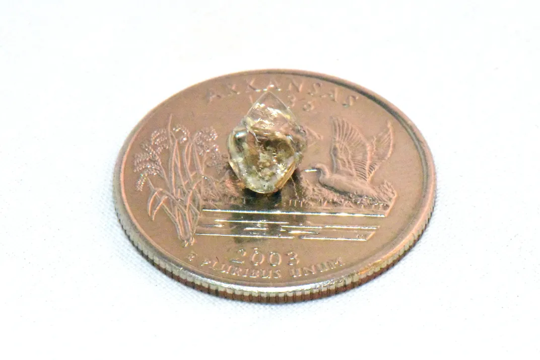 Diamond atop a coin