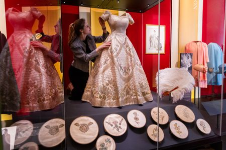 Cecilia Oliver makes final adjustments to Quen Elizabeth II's coronation dress, designed by Norman Hartnell