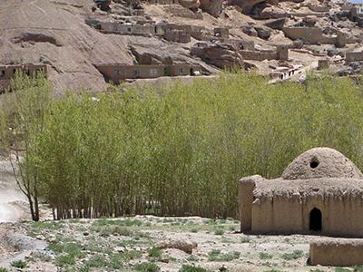 Mud-brick homes dot the hillside along the road from Bamyan City to the Bamyan Family Park.
