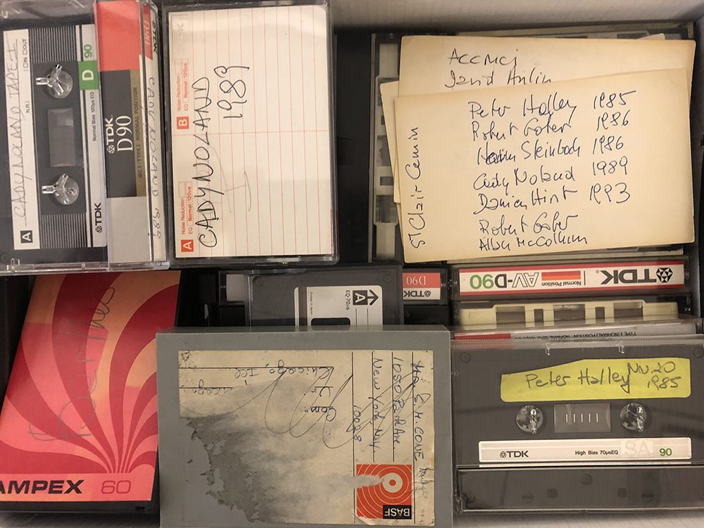 Color image of various audio recordings, some with handwritten labels.