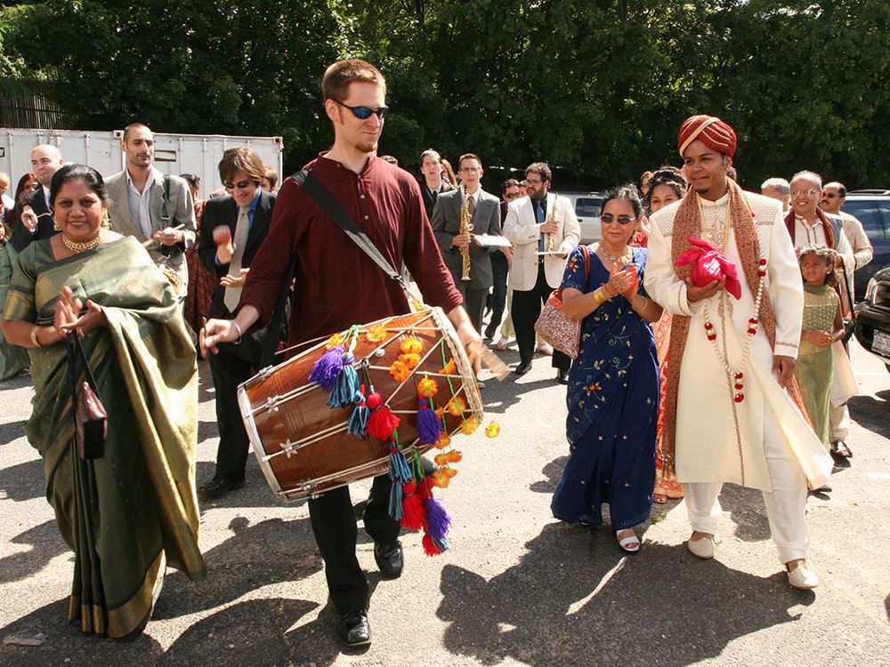After composing and transcribing music for my wedding day, Red Baraat was born. Dave Sharma leads the baraat (wedding procession) on dhol, as I walk with my mother, family, and friends. August 27, 2005. (Photo courtesy of Sunny Jain)