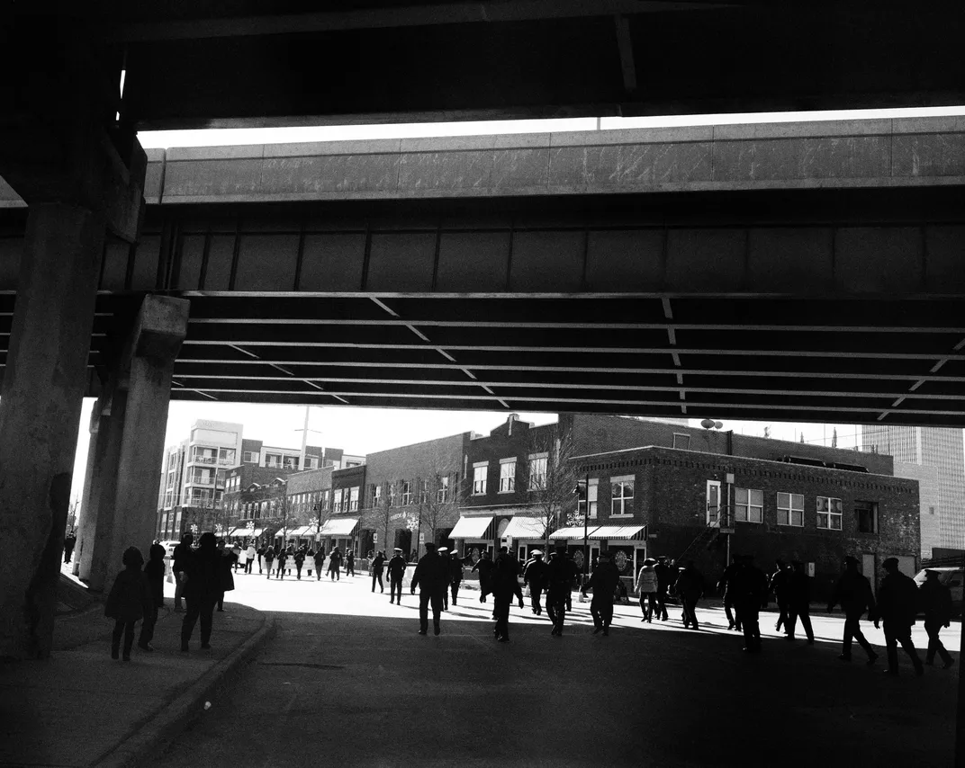 A February 2016 photo of a parade in Tulsa, Oklahoma. Interstate 244 is visible overhead.