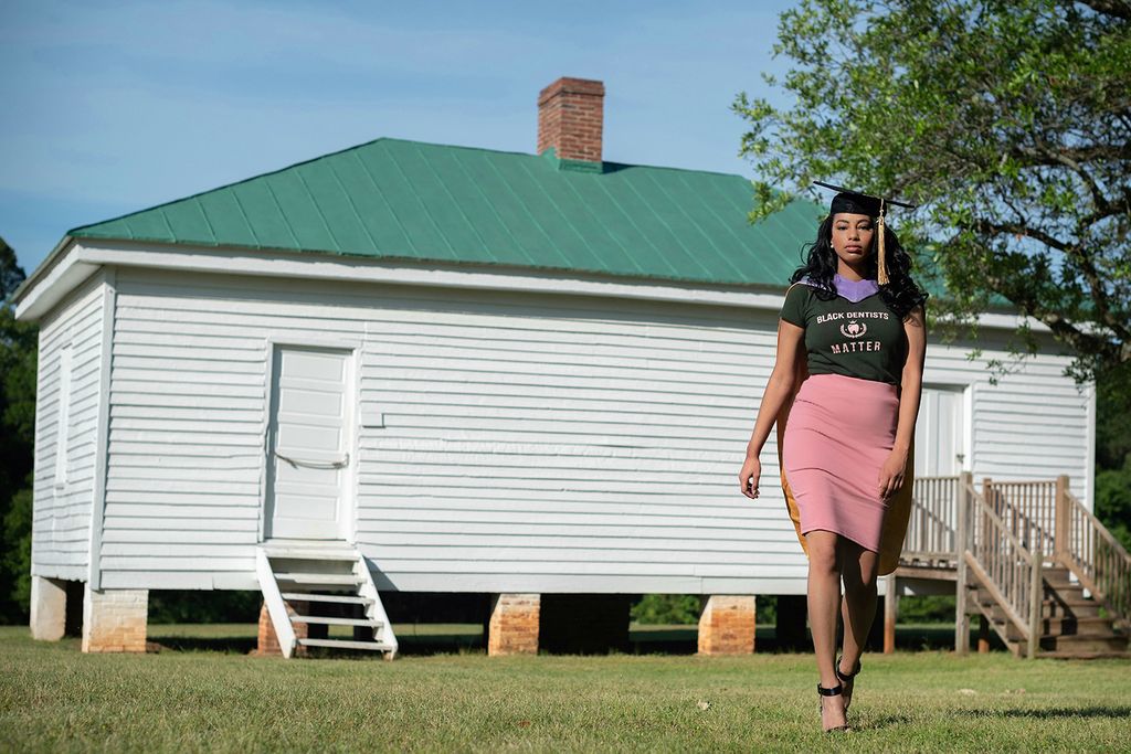 Breanna Henley poses in front of a slave cabin at Redcliffe Plantation in 2021