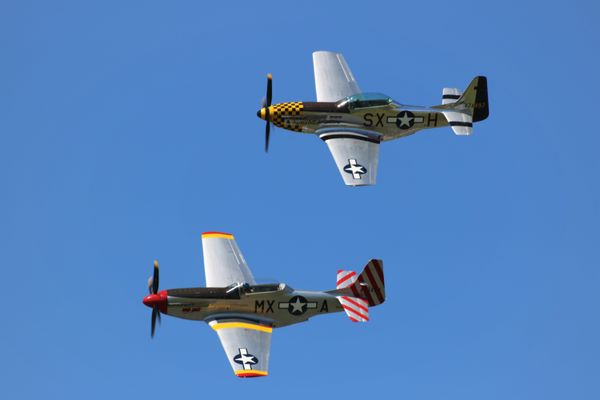 Two historic P-51's in passing formation thumbnail