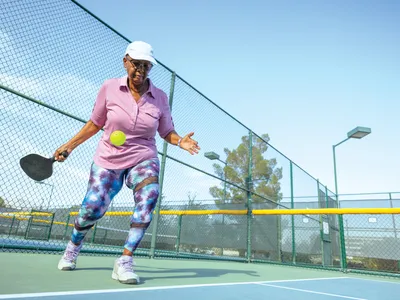 A player serving on an outdoor court. In 2022, the Association of Pickleball Professionals estimated there were 36.5 million pickleball players in the U.S.