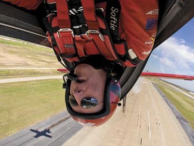 Head games: Fierce concentration is what keeps airshow pilot Greg Poe from knocking his noggin during a low inverted pass. With equal focus, Poe and other aerobatic pilots control their aircraft even during the most chaotic tumbles.