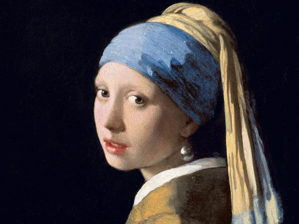 A portrait of a young white woman framed by an all-black background; she turns toward the viewer and wears a blue headscarf and one large, illuminated earring dangling from her left ear; her lips are slightly parted