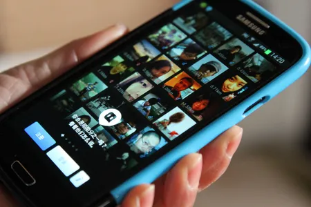 A person looks at profile photos on the messaging app Momo in Shanghai.