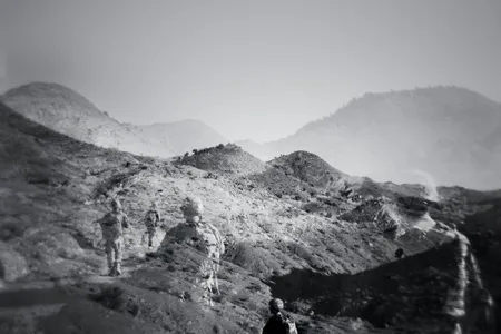 A patrol returns to Forward Operating Base Tillman, in eastern Afghanistan. It was closed in 2012, the year after this double exposure was made.