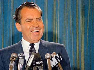 Republican presidential candidate Richard Nixon smiles for the cameras during a 1968 news conference.