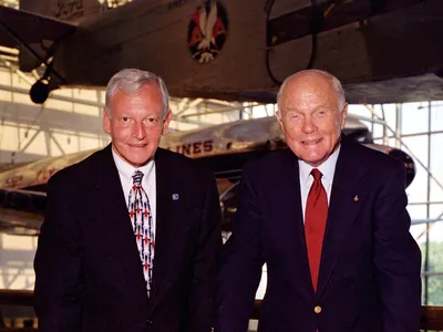 After arriving at the Museum in 2000, Jack Dailey stood with Museum patron John Glenn by a model of the Steven F. Udvar-Hazy Center.