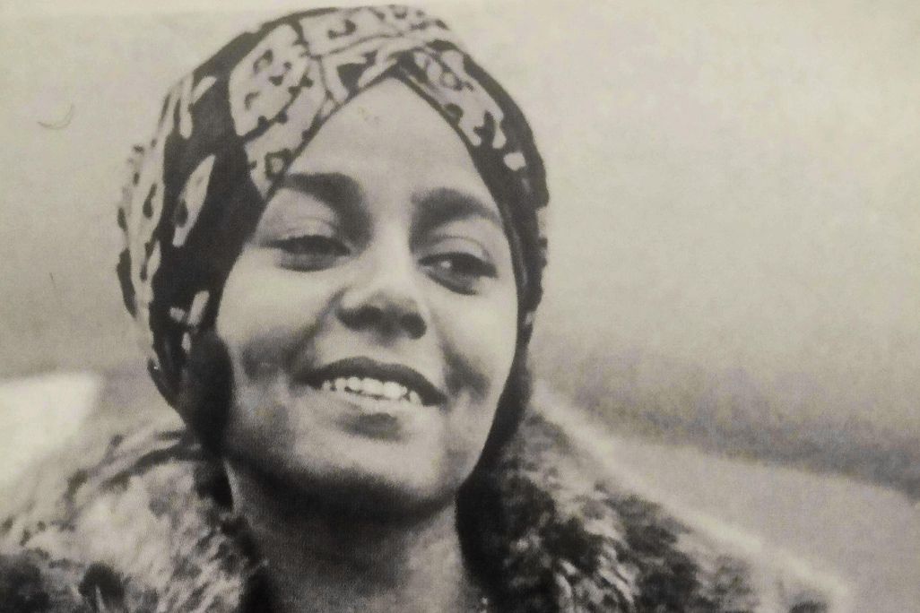 Black-and-white photograph of Stephanie St. Clair, smiling while looking away from the camera
