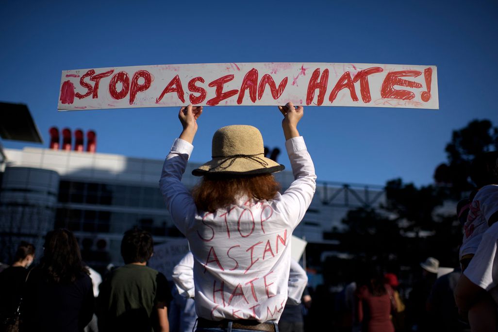 Woman holding sign that says Stop Asian Hate