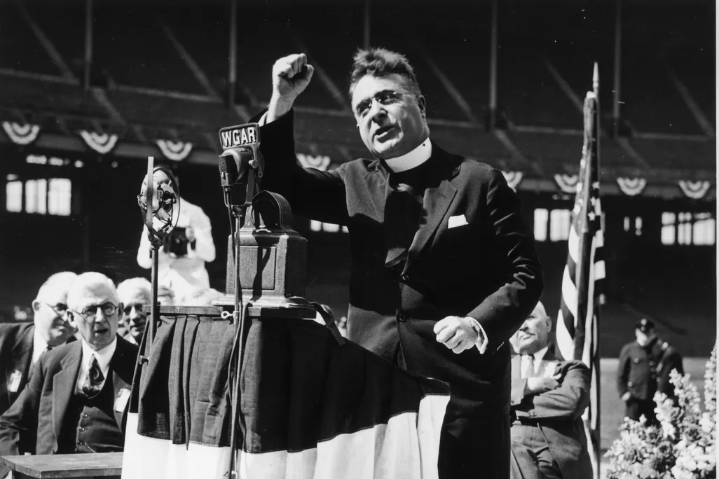 Father Charles Coughlin gives a radio message