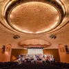 A group of people stand in the center of a large stage