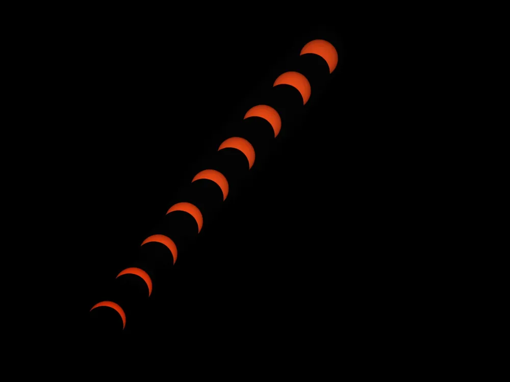 A composite image showing multiple phases of an eclipse as the moon gradually covers the sun