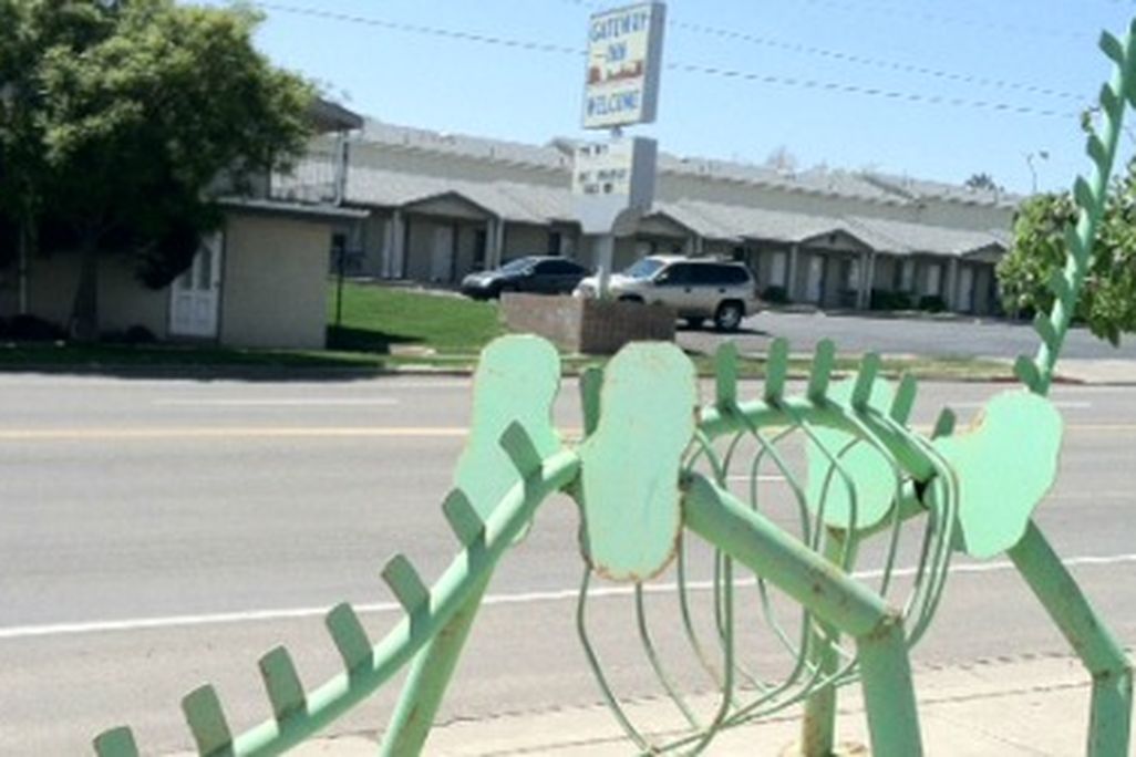 A metallic, skeletal "Brontosaurus" at a Blanding, Utah Sinclair station