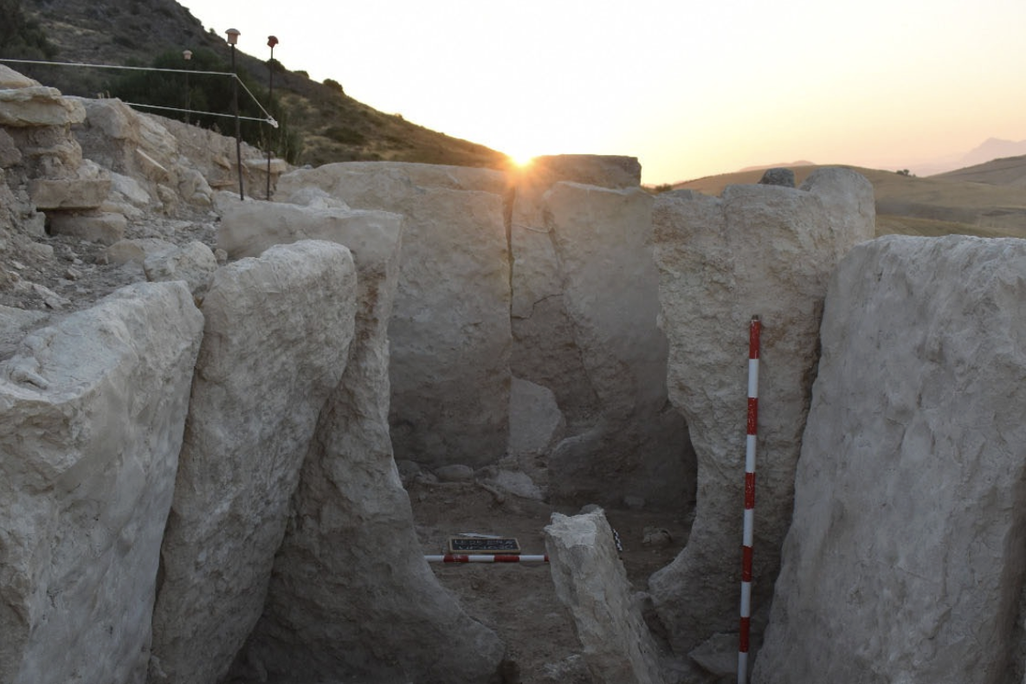 A collection of large stones in front of the sunset
