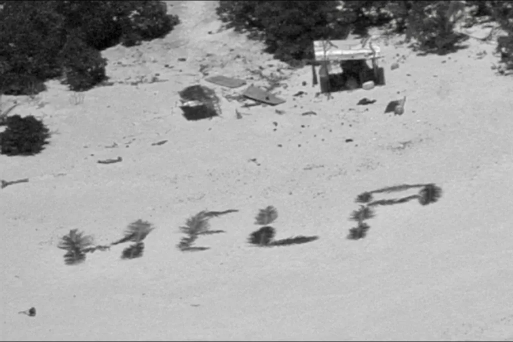 HELP spelled out on beach