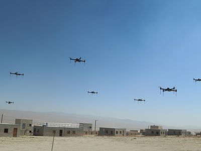 This is only a drill, for now: Over the fictional town of Razish at the National Training Center at Fort Irwin, California, 40 quadcopters fly in a swarm.