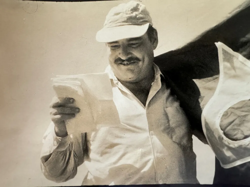 Leicester Hemingway reading a piece of paper