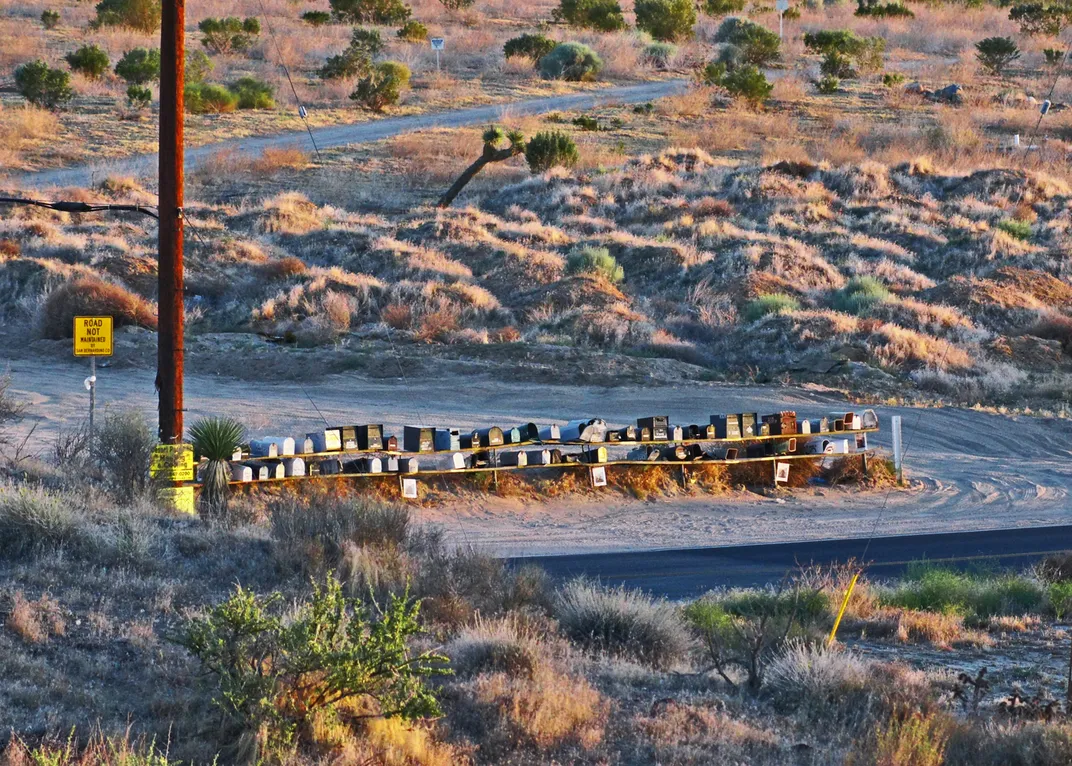 A group of mailboxes in the middle of a road