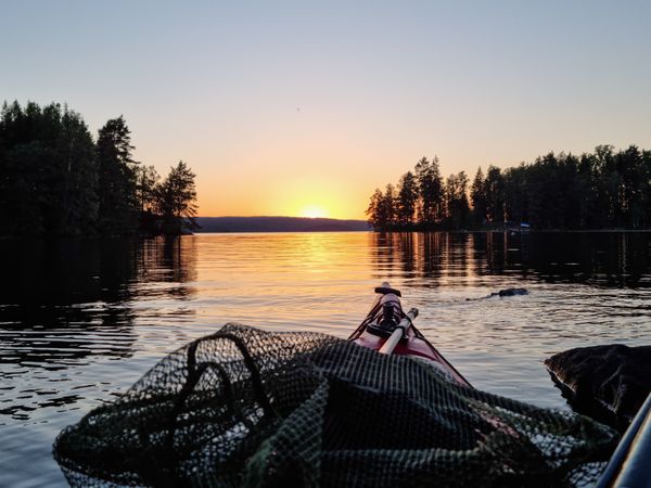 Midnight sun while paddling over a Swedish lake thumbnail