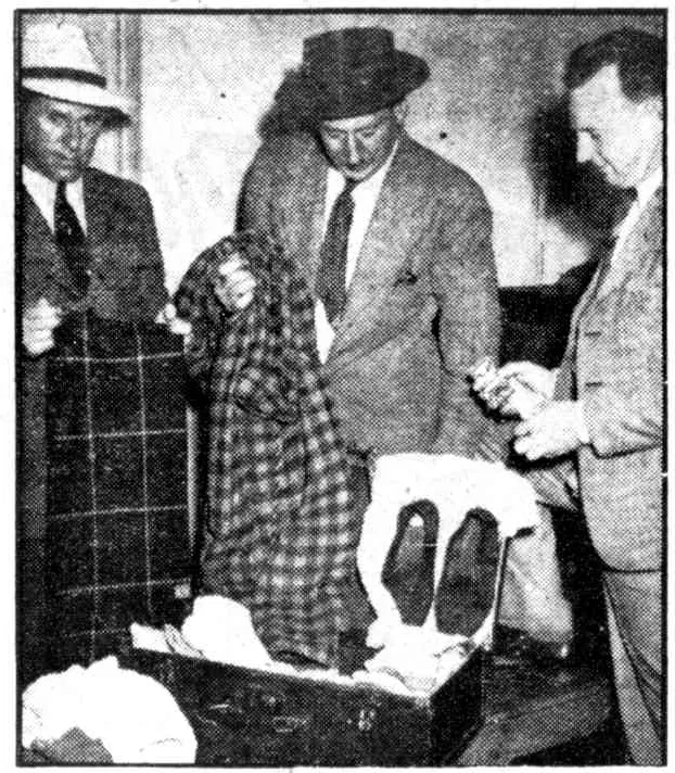 Police examine clothing found in a suitcase linked to the Somerton Man.