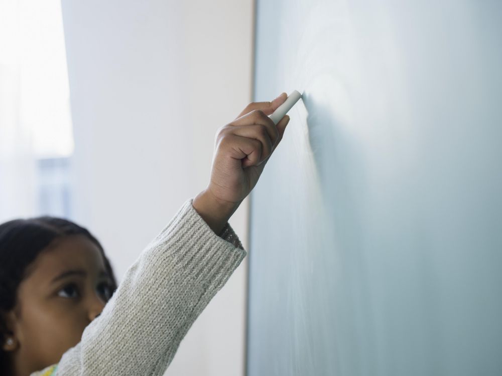 child at chalkboard