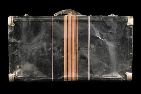 This black metal suitcase belonged to Iku Tsuchiya. It went with her to Tanforan Assembly Center, then to the Topaz camp, and back home to San Leandro, California. (NMAH)