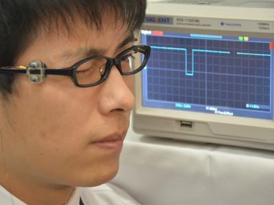 A TEMS device mounted on eyeglasses, with the electrical signal recorded.