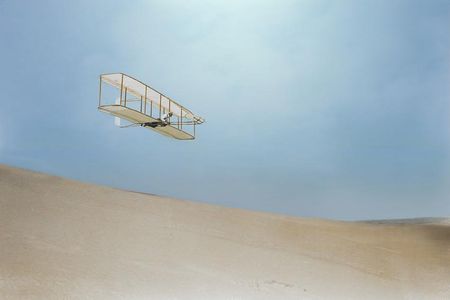 1902: Wilbur Wright gliding down the steep slope of Big Kill Devil Hill.