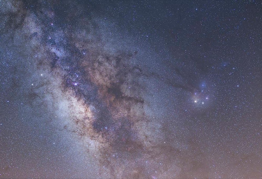 A pastel blue, purple and pink image of the Milky Way